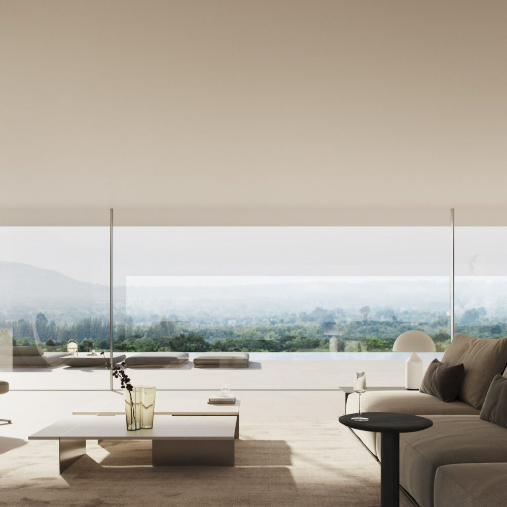 Interior de la lujosa Villa 46 con vistas panorámicas a un paisaje verde y mujer en la ventana.