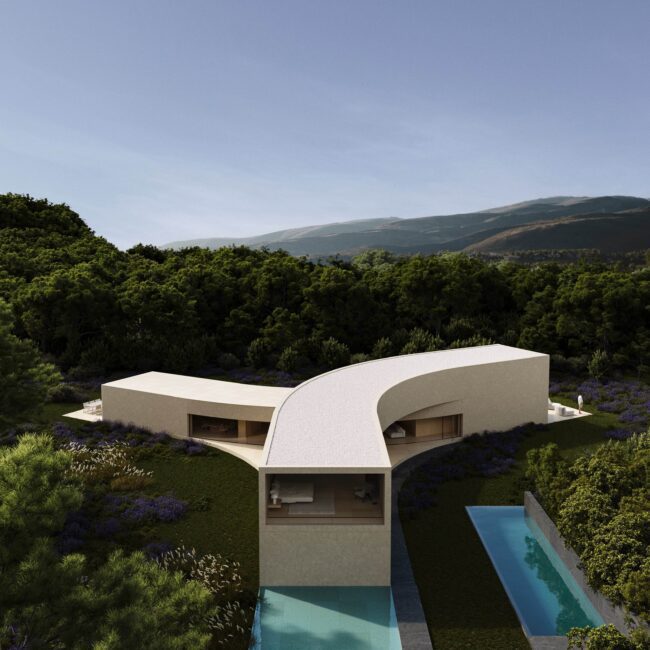 Aerial view of a modern Y-shaped luxury villa with two pools, surrounded by lush green trees, purple flowers, and mountains.