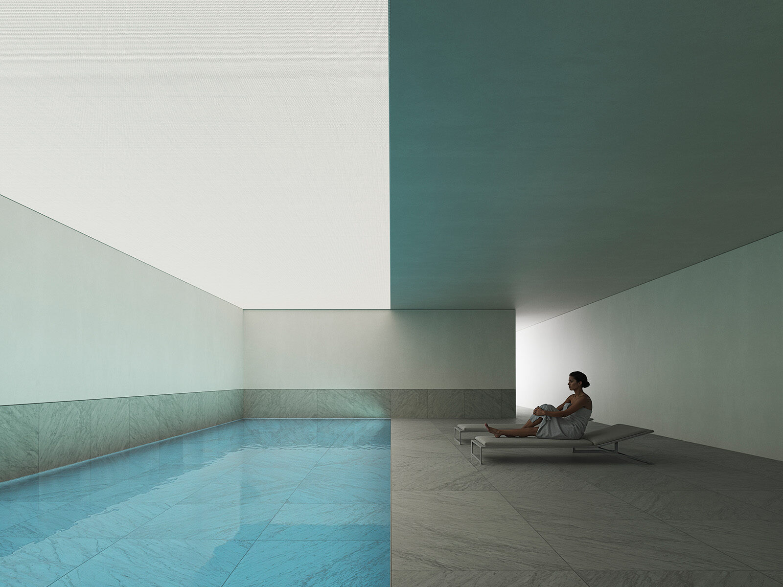 Serene indoor pool and lounging area with a woman on a chaise lounge, reflecting Sotogrande Living comfort.