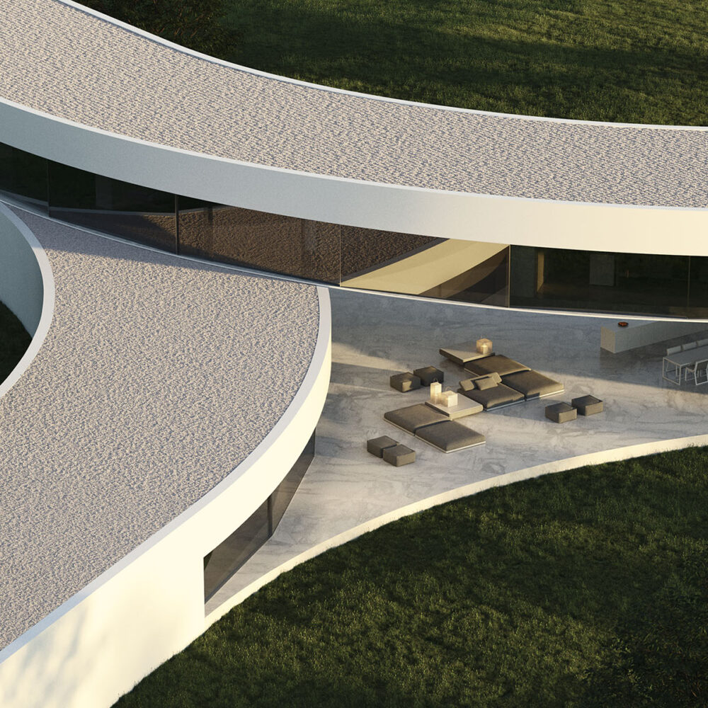Vista aérea de una moderna villa de lujo con arquitectura curva, amplios ventanales, patio y césped.