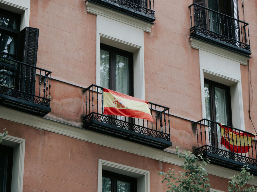 Red and yellow Spanish flags on traditional balconies, Costa del Sol.