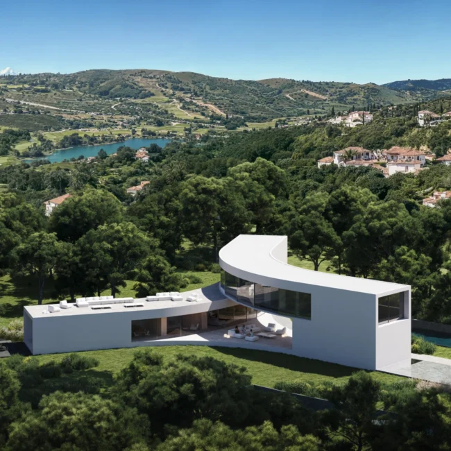 Aerial view of a modern curved white villa with a pool overlooking a golf course, lake, and houses in Sotogrande.
