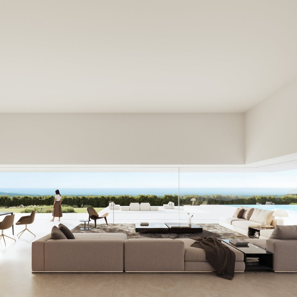 Spacious modern living and dining room in a Cork Oak Mansion with large windows showing sea views, a pool, and a woman.