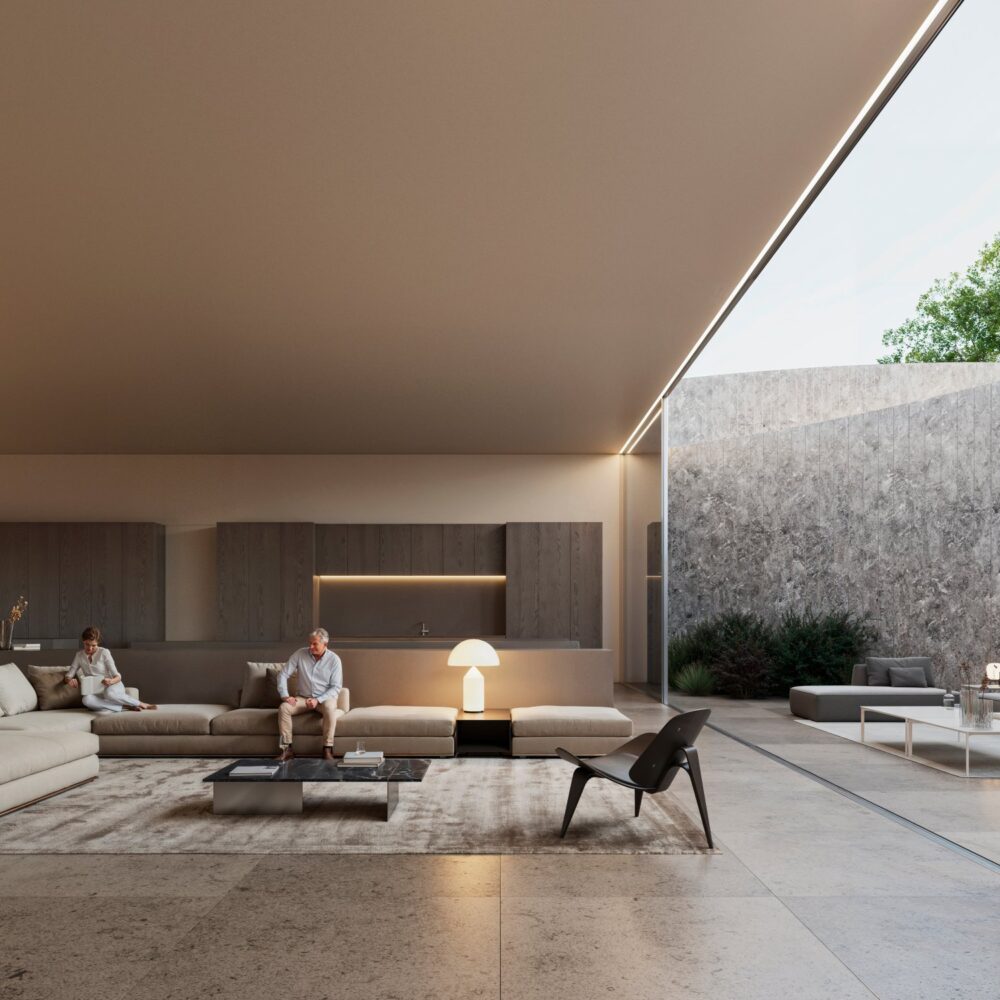 Sleek, open-plan living area in a luxury villa with a couple, leading to a minimalist outdoor space.